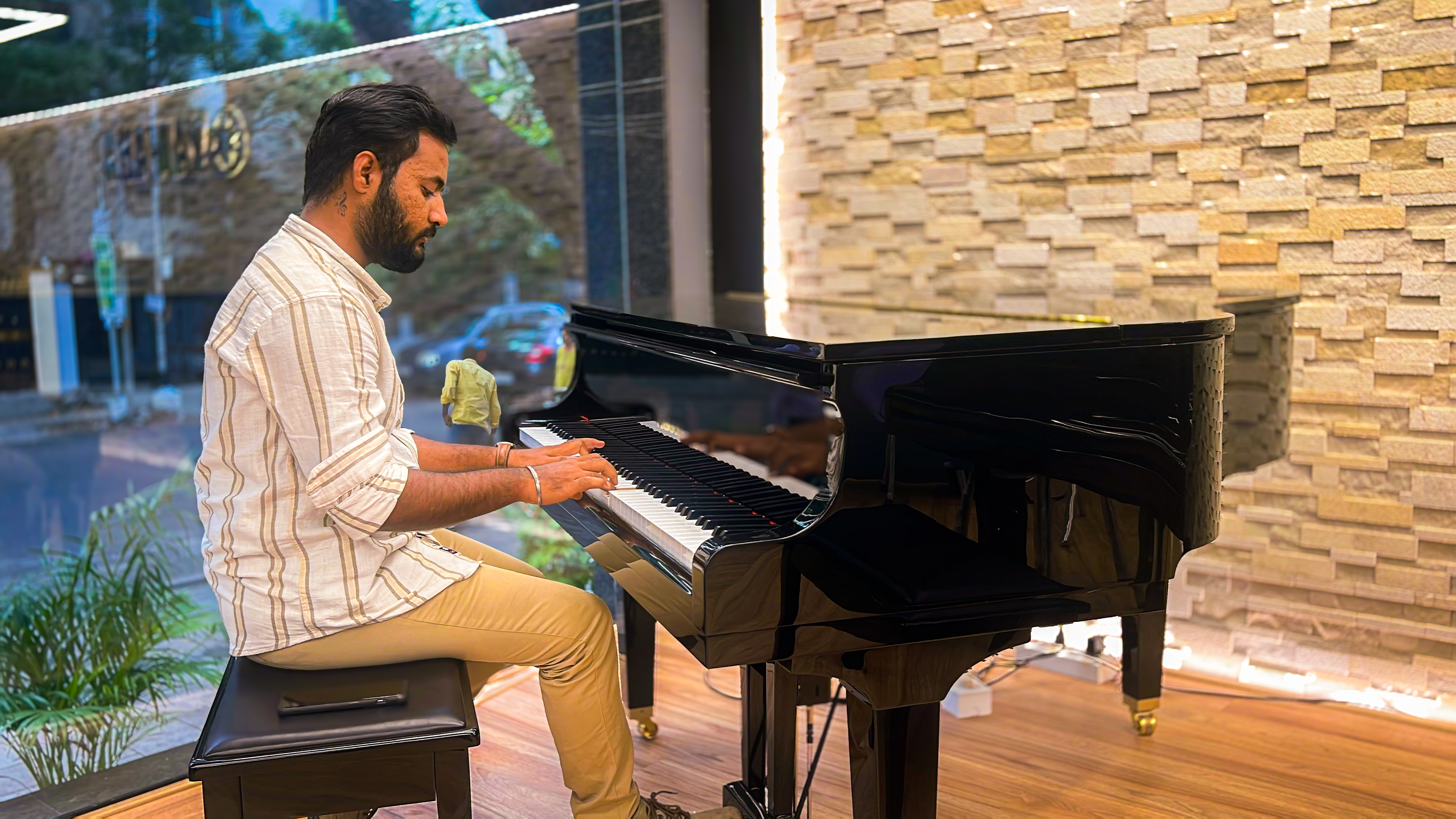 Akhil playing a grand piano